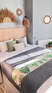 a bedroom with a bed with a comforter on it at Boho apartment studio in Batumi