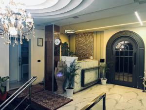 a lobby with a fireplace and a chandelier at Blackout Bar & Hotel in Hanumāngarh Junction