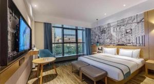 a hotel room with a bed and a large window at City Comfort Inn Suzhou Wujiang Development Zone Yundong in Suzhou +110 photos