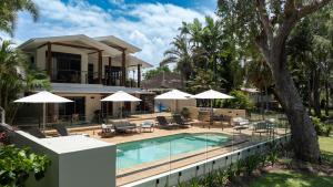 a villa with a swimming pool and a house at Latitude 17 - Suite 2 in South Mission Beach