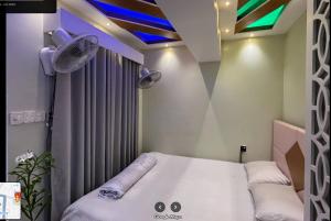 Hotel The Manha LTD Purana Paltan في داكا: غرفة بسرير في غرفة مع ستارة