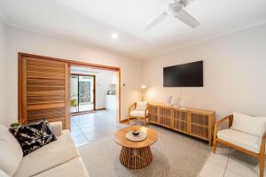 a living room with a couch and a table at Latitude 17 - Suite 4 in South Mission Beach