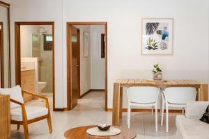 a living room with a table and white chairs at Latitude 17 - Suite 4 in South Mission Beach