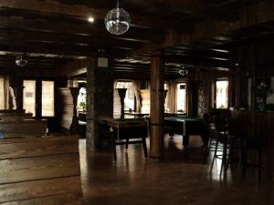 a large room with a pool table and chairs at Kovács Hotel Superior in Vásárosnamény