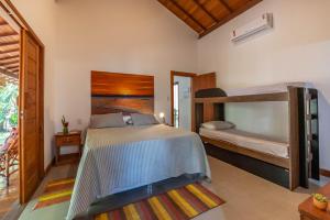 a bedroom with two bunk beds and a balcony at Casa alto padrão próximo a praia, suíte, jacuzzi in Marau