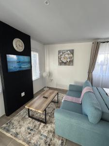 a living room with a blue couch and a table at Peaceful and Luxurious Hidden Cove in Gqeberha +13 photos