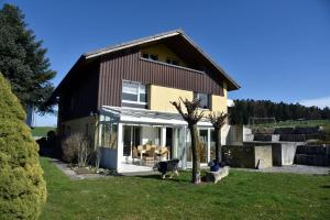 a house with a dog standing in front of it at Haslers Hof in Dinhard