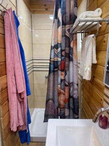 a bathroom with a shower curtain and a sink at Relax Home Nazareth Rawaqan 2026 منتجع روقان צמר נצרת in Nazareth