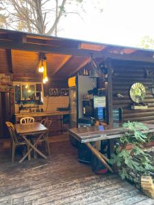 a kitchen and dining area of a cabin with a table at Relax Home Nazareth Rawaqan 2026 منتجع روقان צמר נצרת in Nazareth +3 photos