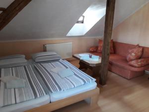 a bedroom with a bed and a couch at Fewo Am Triebischbrunnen in Meißen +5 photos