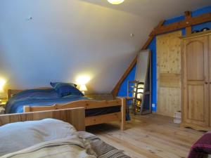a bedroom with two bunk beds and a ladder at Au Paradis des 4 Saisons in Héric
