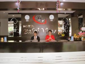 two women sitting at the counter of a hotel bar at Balai View Hotel in Tanjung Balai Karimun