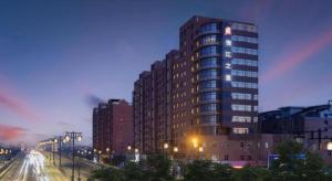 a tall building in a city at night with street lights at JinJiang Inn Datong Pingchengqiao in Datong
