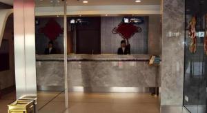 two people standing in front of a counter in a restaurant at JinJiang Inn Datong Pingchengqiao in Datong +129 photos