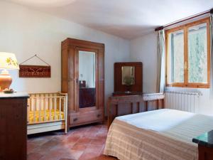 a bedroom with a bed and a crib in it at Agriturismo Lucciano in San Casciano in Val di Pesa