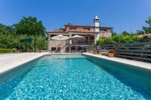 a house with a swimming pool in front of a house at House Matija in Svetvinčenat