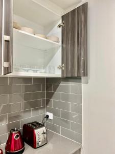 a kitchen with a toaster on a counter at Mahzan on Kilcunda - Ensuite 4 in Truganina +23 photos