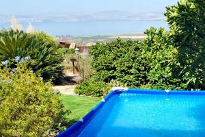 una piscina azul con vistas al océano en נופי גמלא, en Ma'ale Gamla