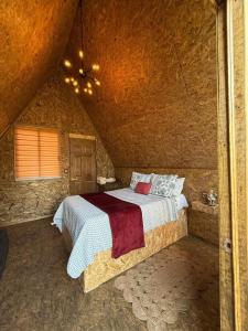 a bedroom with a bed in a stone room at Valle Colibrí in Tuxpan