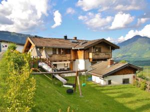 a house with a slide in front of it at Apartment Wiesbachhorn Zell am See-Kaprun in Kitzsteinhorn