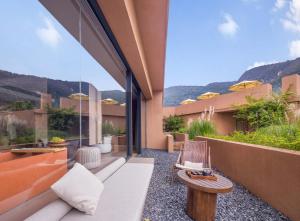 an outdoor patio with a couch and a table at Zhangjiajie Shisuji Hotel (Zhangjiajie National Forest Park Sign Gate Branch) in Zhangjiajie