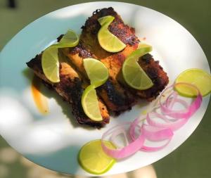 a white plate with a piece of food and some onions at La Isla Bonita in Guraidhoo