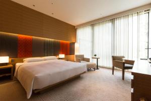 a hotel room with a large bed and a desk at Hyatt Regency Kyoto in Kyoto