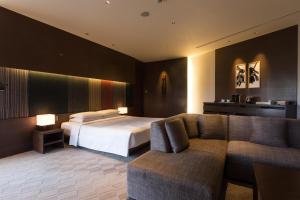 a hotel room with a bed and a couch at Hyatt Regency Kyoto in Kyoto
