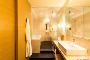 a bathroom with a sink and a mirror at Hyatt Regency Kyoto in Kyoto