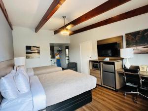 a bedroom with a bed and a desk and a television at Quality Inn - On The Lake Clarksville-Boydton in Clarksville