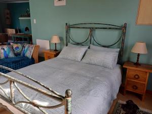 a bedroom with a large bed and a couch at Pool House at the Old Victorian in Tulbagh +18 photos