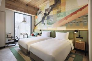 東京にあるCaption By Hyatt Kabutocho Tokyoのホテルの部屋にはベッドが2つあり、