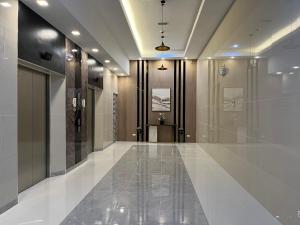 a hallway of a building with a glass door at Aspen Suites Condo in Davao City
