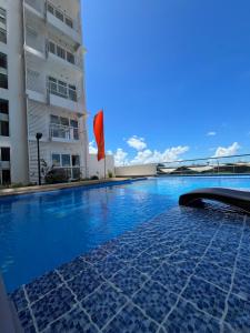 a swimming pool in front of a building at Aspen Suites Condo in Davao City