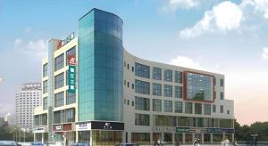 a large building with a sign on the side of it at Jinjiang Inn Weihai High Speed Qingdao South Road in Weihai