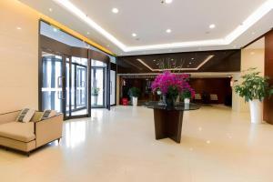 a lobby with a couch and a table with flowers at Yitel Collection Shanghai Hongqiao Airport in Shanghai