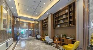 a lobby with chairs and a table in a building at Yitel Collection Harbin Railway Station Museum Metro Station in Harbin