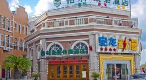 a building with a sign on top of it at GreenTree Inn Taicang Baolong Square Hotel in Taicang