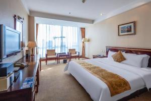 a hotel room with a large bed and a television at Datong Tiangui International Hotel in Datong