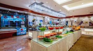 a buffet line with food on display in a restaurant at Datong Tiangui International Hotel in Datong
