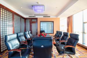 a conference room with chairs and a table with flowers at Datong Tiangui International Hotel in Datong