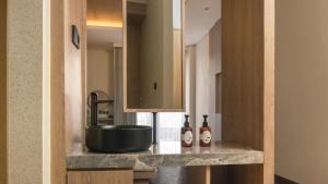 a bathroom with a sink and a mirror at Jambuluwuk Bromo Resort in Pasuruan