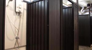 a bathroom with a shower with a black door at Mini Boxtel Aonang Hostel in Ao Nang Beach