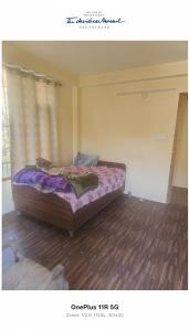 a bedroom with a bed in a room at Rangoli cafe and home stay in Vashisht