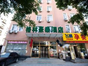 a pink building with a sign on top of it at GreenTree Inn Chaoyang Shuangta District Bus Station in Chaoyang