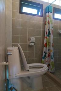 a bathroom with a toilet with a shower curtain at Tamarina Resort in Ban Puk (1) +84 photos