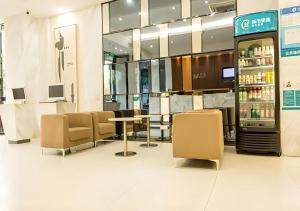 a restaurant with a table and chairs and a drink cooler at City Comfort Inn Nanning Guangxi University Xiuling Road Metro Station in Nanning