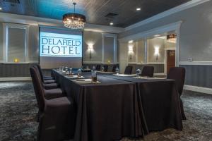 a conference room with a long table and chairs at The Delafield Hotel in Delafield