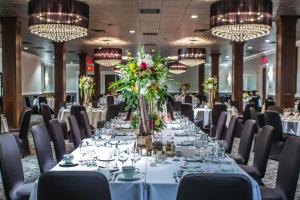 a dining room with tables and chairs and chandeliers at The Delafield Hotel in Delafield