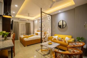 a hotel room with a bed and a couch at BedChambers Luxurious Aparthotel Near Medicity in Gurgaon